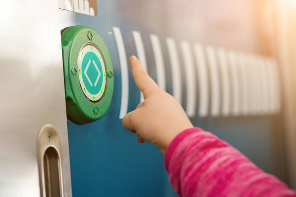Kids finger pushing green round touch button with arrows. Transparent door between carriages in intercity train. Modern sensot technologies - Photo, Image