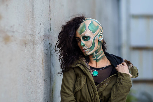 Young woman with makeup of green skull for halloween. - Foto, Imagen
