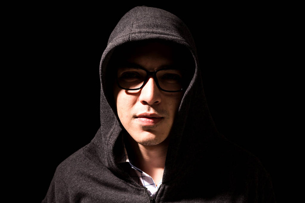 Hacker in a hood on dark background - Photo, Image