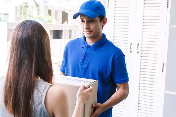 Woman accepting a delivery boxes from delivery man - Photo, Image