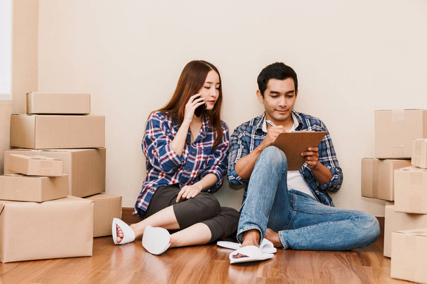 Lista di controllo giovane coppia con scatola di cartone a casa - Business online e concetto di consegna
 - Foto, immagini