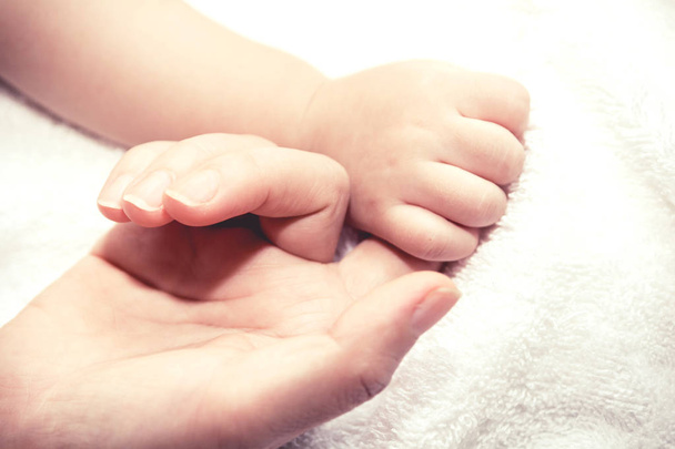 Äiti pitää kädestä vauvan
 - Valokuva, kuva