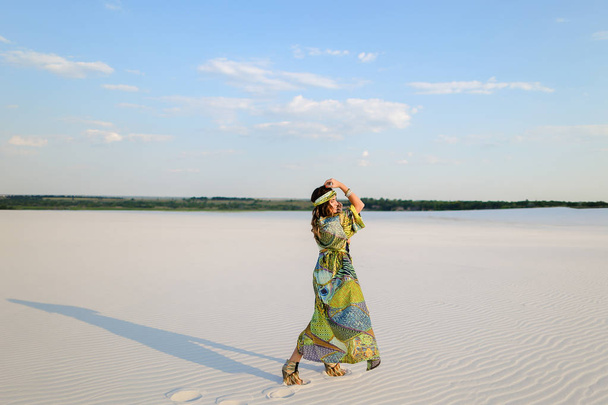 Fashionable woman wearing swimsuit and beach robe dancing on san - Photo, Image