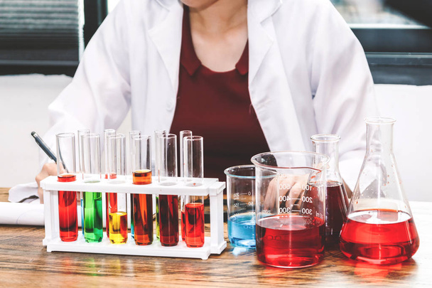 Laboratory glassware with female laboratory scientist in science research laboratory - Foto, Imagen