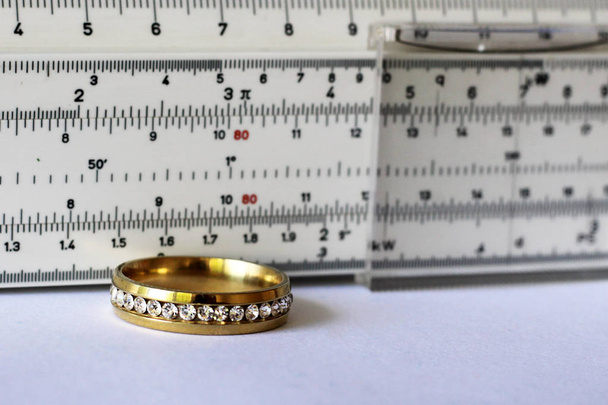 Gold ring with diamonds and a measuring instrument, the value of jewelry, object - Photo, Image