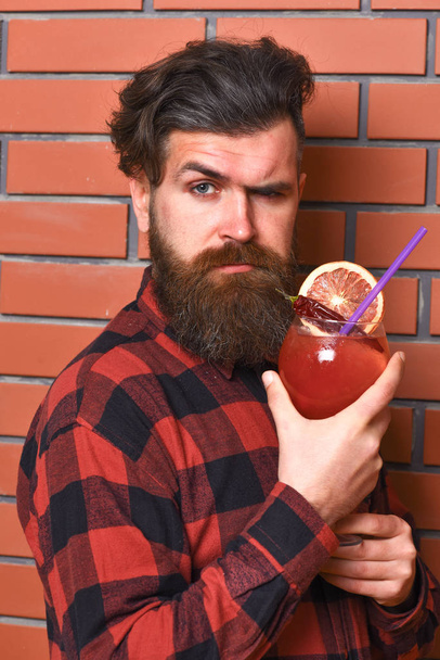 Barman with beard and strict grimace face holds glass - Fotografie, Obrázek