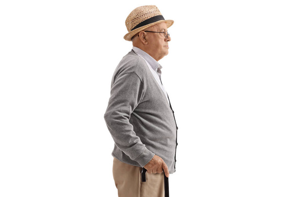 Profile shot of a senior with a cane isolated on white background - Фото, зображення