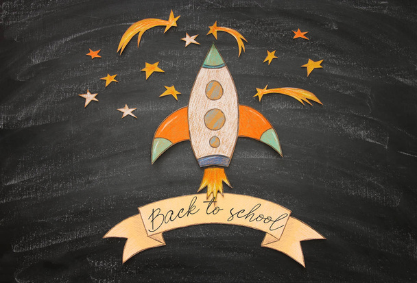 Back to school concept. rocket, space elements shapes cut from paper and painted over classroom blackboard background - Φωτογραφία, εικόνα