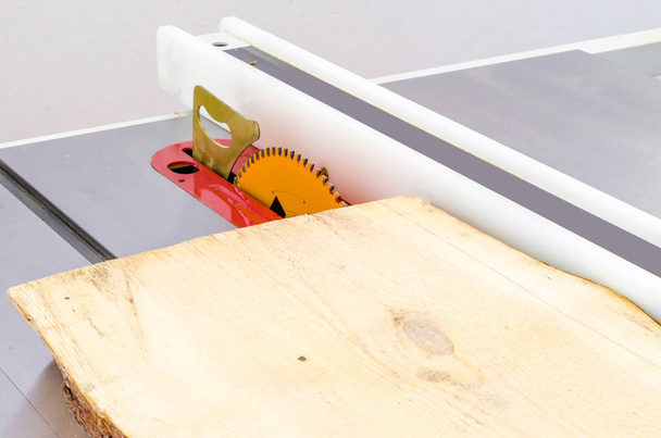 Cortar la tabla en una sierra circular en un taller de carpintería
 - Foto, imagen
