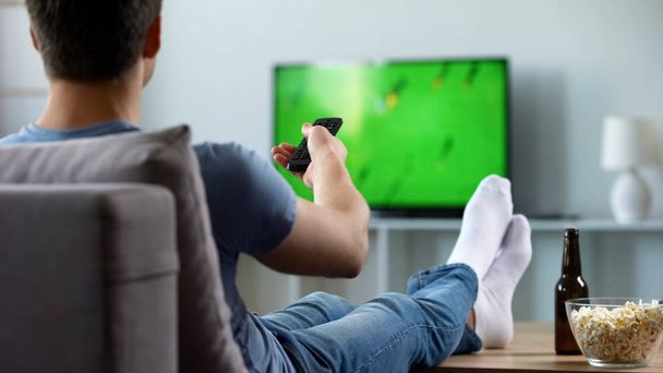 Sport fan watching recording of missed soccer match, modern smart tv technology - Φωτογραφία, εικόνα