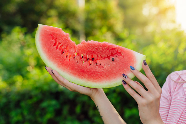 Close up red juicy watermelon in woman's hands - Φωτογραφία, εικόνα