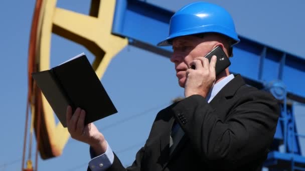 Oil Company Businessman Talk to Mobile with Technic Department Checking Agenda - Záběry, video