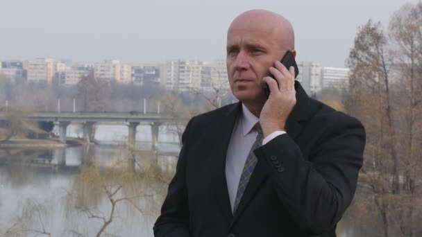 Slow Motion View with a Confident Businessman Talking Serious to Cell Phone. - Imágenes, Vídeo