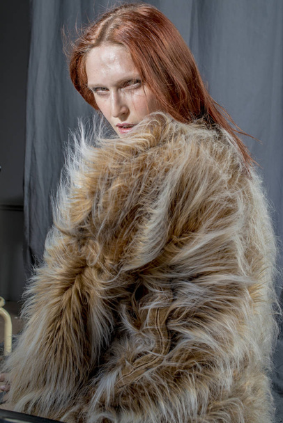Young beautiful woman in a fur coat glamorous image - Fotó, kép