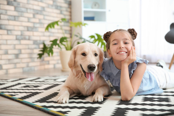 Cute little child with her pet on floor at home - Photo, image