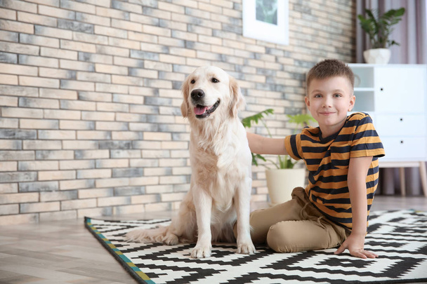 Cute little child with his pet on floor at home - Photo, Image