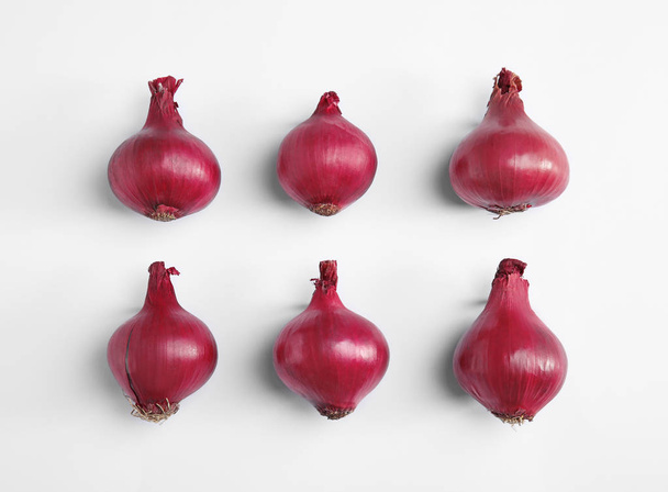 Beautiful composition with ripe red onions on white background - Photo, Image