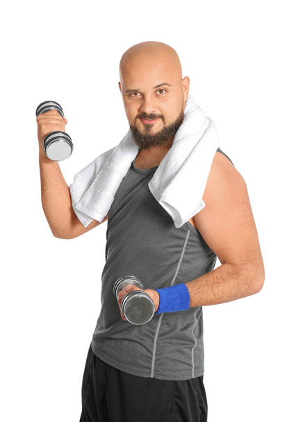 Overweight man doing exercise with dumbbells on white background - Zdjęcie, obraz