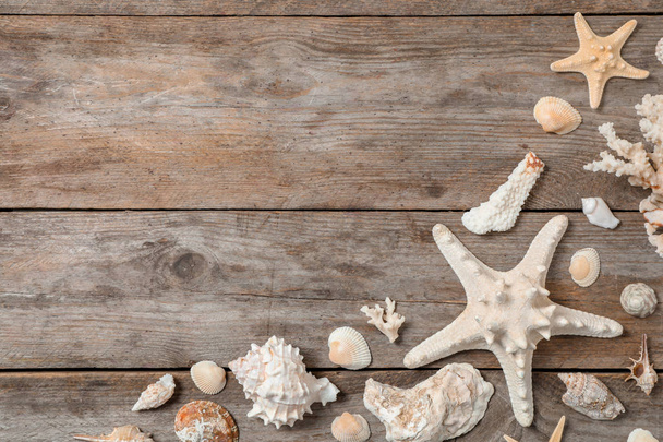 Flat lay composition with seashells on wooden background. Beach objects - Fotó, kép