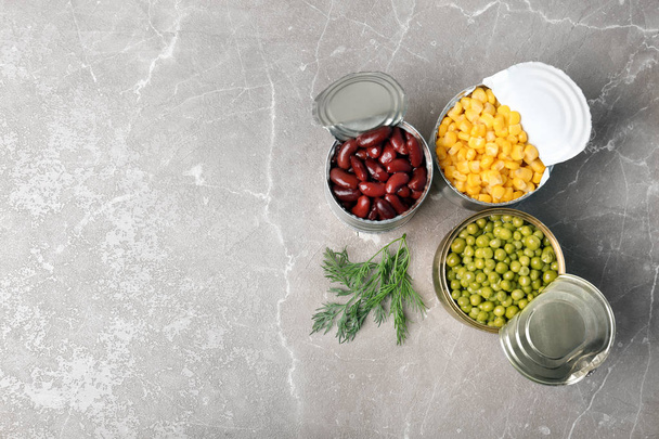 Flat lay composition with canned vegetables on grey background - Photo, Image