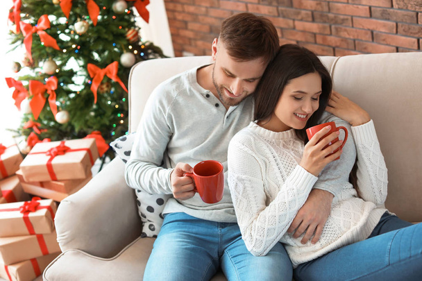 Happy young couple celebrating Christmas at home - Foto, Imagen