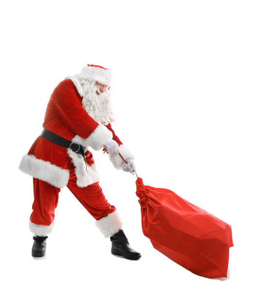Authentic Santa Claus with red bag full of gifts on white background - Photo, image