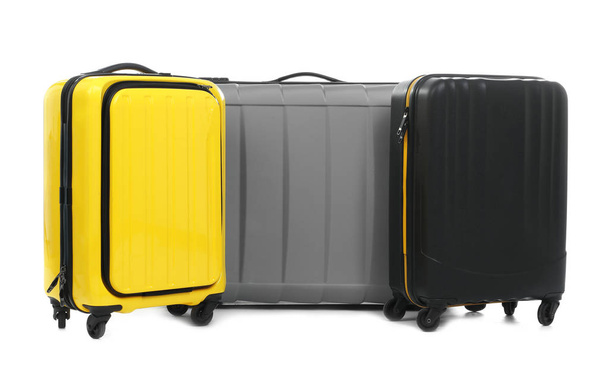 New suitcases packed for journey on white background - Foto, Imagen