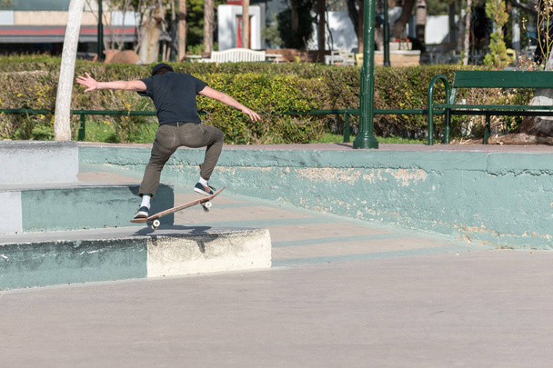 Skateboarder doing a skateboard trick in the skatepark. - 写真・画像