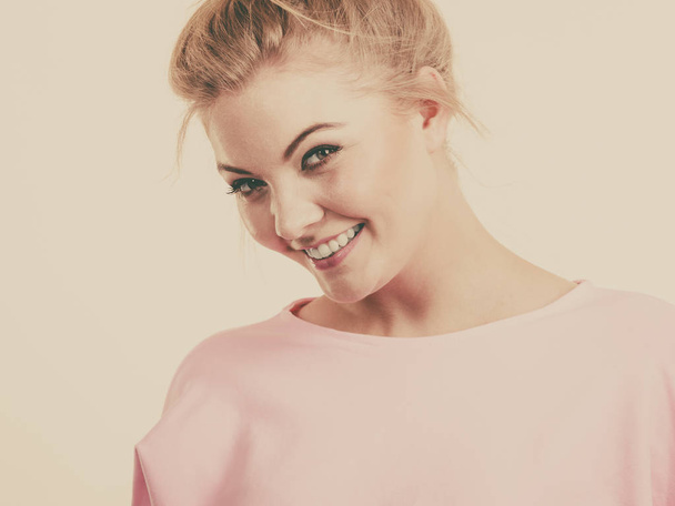 Happy positive cheerful smiling woman wearing pink dress with blonde hair. Fashion model - 写真・画像
