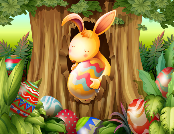 Um coelho dentro do buraco de uma árvore cercada de ovos
 - Vetor, Imagem
