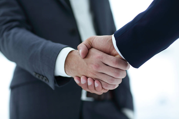 close up of two young male business partner shake hand - Фото, изображение