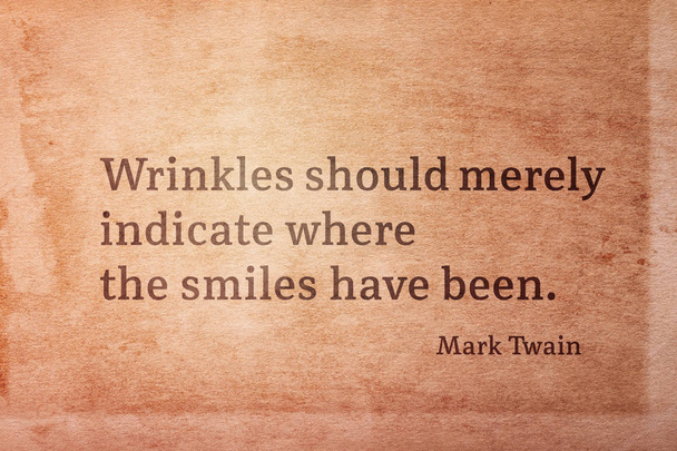 Wrinkles should merely indicate where the smiles have been - famous American writer Mark Twain quote printed on vintage grunge pape - Photo, Image