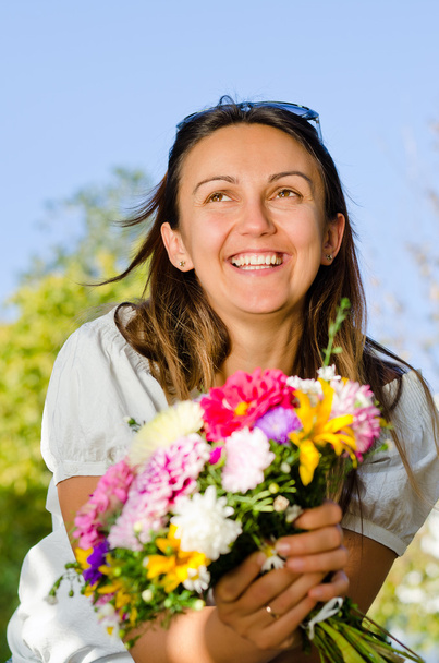 Happy laughing woman with flowers - 写真・画像
