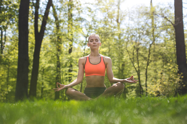 Tranquil lady is meditating outdoors - Photo, image
