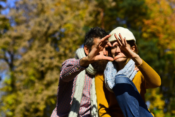 Dating and autumn love concept. Man and woman show heart - Photo, Image