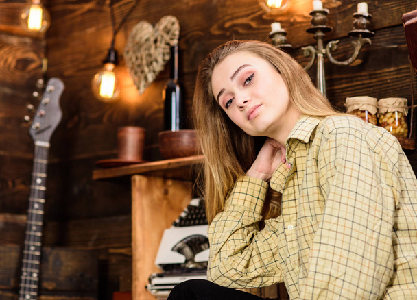 Girl tomboy spend time in house of gamekeeper. Tomboy concept. Lady on dreamy face in plaid clothes looks cute and casual. Girl in casual outfit in wooden vintage interior - Фото, зображення