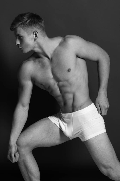 Sports, clothes and healthy lifestyle concept. Athlete with confident face wearing white underwear - Fotoğraf, Görsel