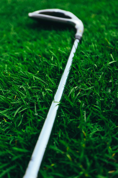 Golf stick on a green grass background, blurred macro view, luxury sport play game lifestyle concept. - Photo, Image