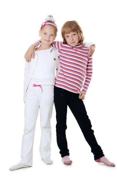 Two young girl friends on white background - Foto, afbeelding