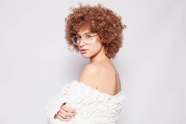 Portrait of smiling young black woman. Portrait of a beautiful young woman with African American afro haircut and glamor makeup. Studio shot. Attractive girl wearing eyeglasses. - Valokuva, kuva