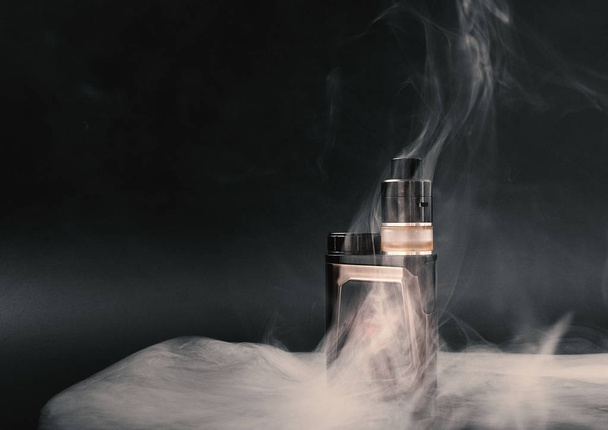 modern electronic cigarette on a black background - Foto, Bild