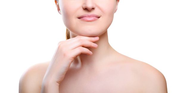 Portrait of girl with nude make-up with hands on chin isolated on white background. Girl with clean healthy skin on white. Cosmetology, medicine, beauty care. Nude makeup - Фото, зображення