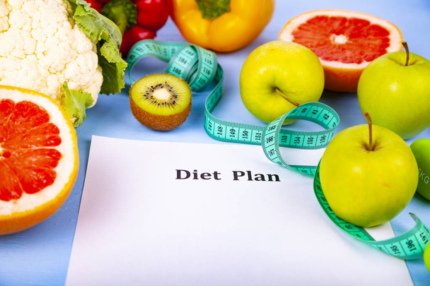 Food and sheet of paper with a diet plan on a blue wooden background. Concept of diet and healthy lifestyle. - 写真・画像