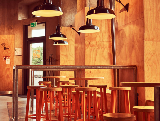 Interior of new modern restaurant or cafe with wooden wall and furniture. - Fotoğraf, Görsel