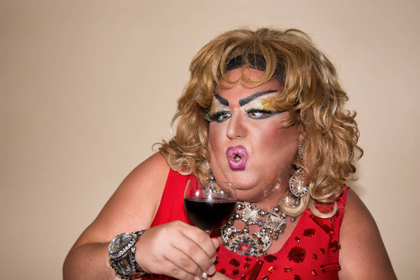 Funny travesty actor. Drag queen and red wine. Feelings and emotions - Photo, Image