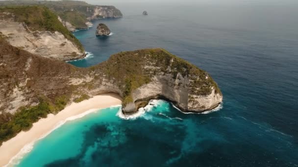 Rocky cliff with beach in the sea. Karang Dawa. - Footage, Video