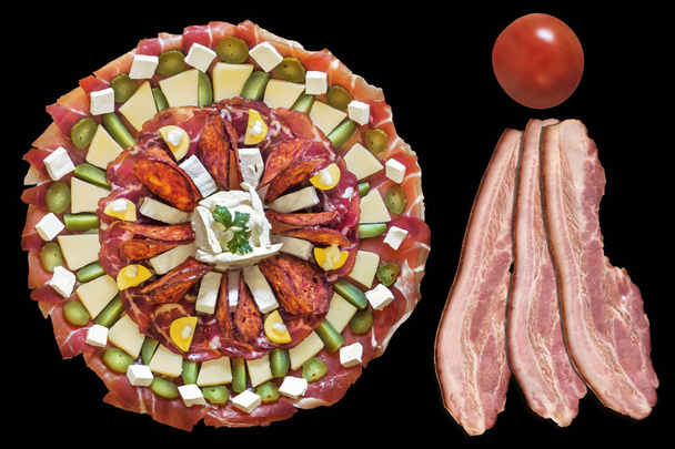Garnished Appetizer Savory Dish with Three Pork Belly Bacon Rashers and Cherry Tomato Isolated on Black Background - Photo, Image