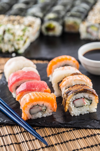 Set of roll sushi gold california with chopsticks and soy sauce. - Photo, Image