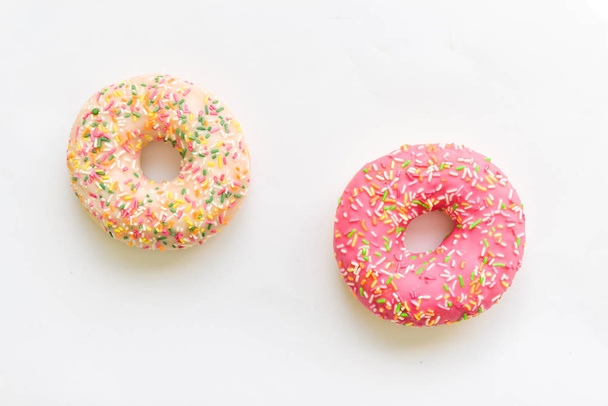 Donut with colorful sprinkles isolated on background. - Foto, immagini