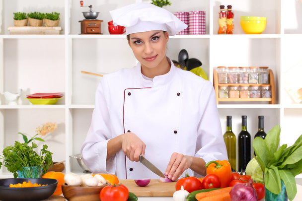 Young woman chef cooking in kitchen - Fotografie, Obrázek